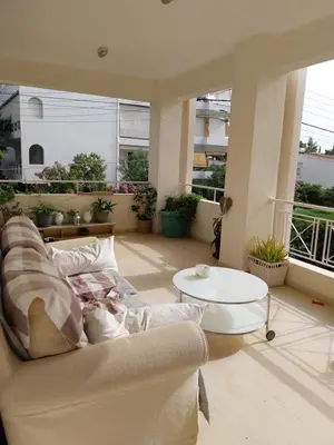 a living room with a couch and a table at Hope house Kavouri in Athens