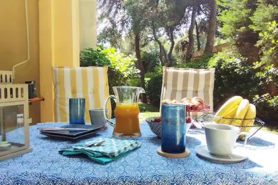 a table with a blue table cloth with drinks on it at Garden Apartment with BBQ in the Athenian Riviera in Athens