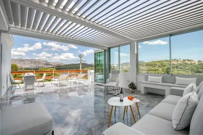 a living room with white furniture and large windows at South Blue Sea View Apartment in Athens