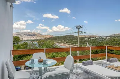 a balcony with a table and chairs and a view of the city at South Blue Sea View Apartment in Athens