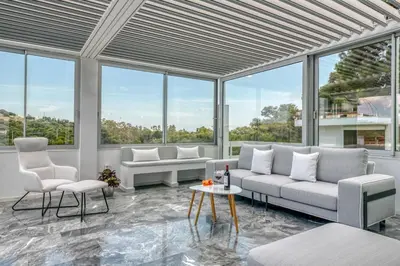 a living room with white furniture and large windows at South Blue Sea View Apartment in Athens