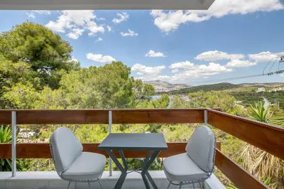 a table and two chairs on a balcony with a view at South Blue Sea View Apartment in Athens