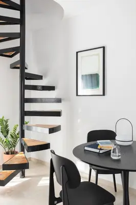 a dining room with a table and chairs and a staircase at Elliot Neapoli, Athens in Athens