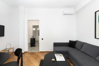 a living room with a couch and a table at Elliot Neapoli, Athens in Athens