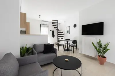 a living room with a couch and a table at Elliot Neapoli, Athens in Athens
