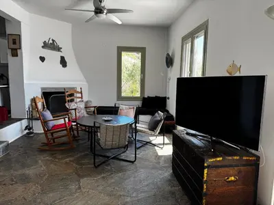 a living room with a large flat screen tv at Attica Vacation Home in Dhaskalión