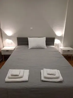 a bedroom with a bed with two towels on it at Embassy Apartment - I2 in Athens