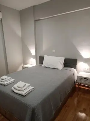 a bedroom with a bed with two towels on it at Embassy Apartment - I2 in Athens