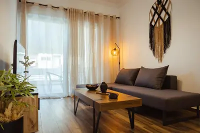 a living room with a couch and a table at Aria apartment in Athens