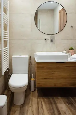 a bathroom with a white toilet and a mirror at Aria apartment in Athens