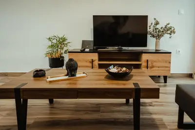 a living room with a coffee table and a tv at Aria apartment in Athens