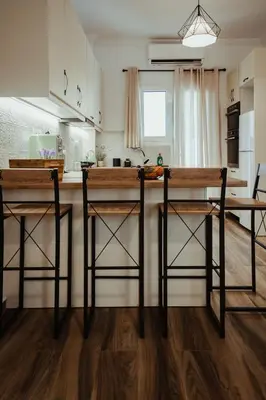 a kitchen with a counter and two bar stools at Aria apartment in Athens