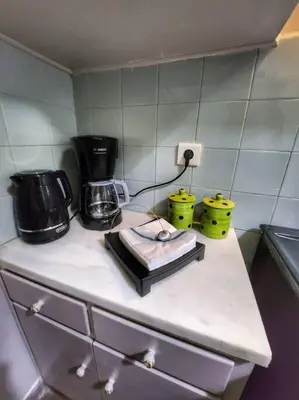 a kitchen counter with two coffee makers on it at Ilyssos - Boho Stylish apt- Hilton Area Athens in Athens