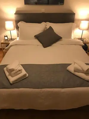 a large white bed with two pillows on it at Marcy's luxurious Penthouse Marina Zeas in Piraeus