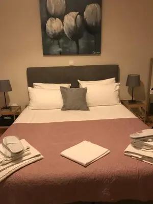 a bedroom with a large bed with towels on it at Marcy's luxurious Penthouse Marina Zeas in Piraeus
