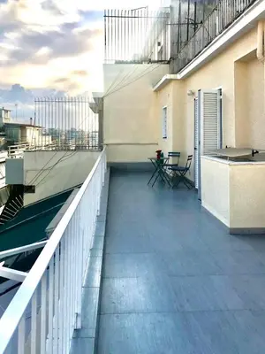 a balcony with a table and chairs on a building at Marcy's luxurious Penthouse Marina Zeas in Piraeus