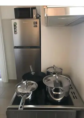 a kitchen with two pots and pans on a stove at Marcy's luxurious Penthouse Marina Zeas in Piraeus