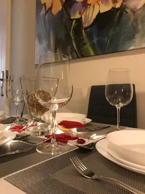 a table with wine glasses and plates on it at Marcy's luxurious Penthouse Marina Zeas in Piraeus