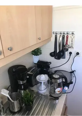 a kitchen counter with a coffee maker and other kitchen utensils at Marcy's luxurious Penthouse Marina Zeas in Piraeus