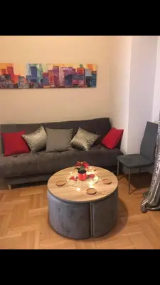 a living room with a couch and a coffee table at Marcy's luxurious Penthouse Marina Zeas in Piraeus