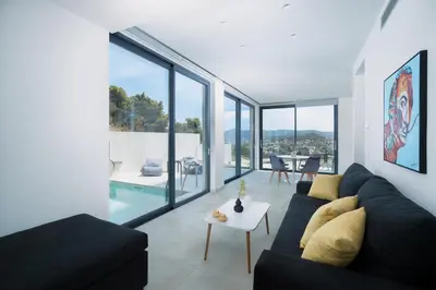 a living room with a couch and a table at White Cliff Luxury Suites in Porto Rafti