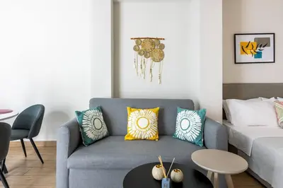 a living room with a couch and a table at The Charm Studio in Glyfada in Athens