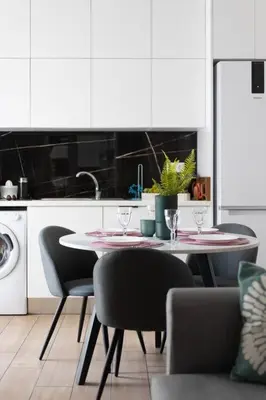 a kitchen with a table and chairs in a kitchen at The Charm Studio in Glyfada in Athens