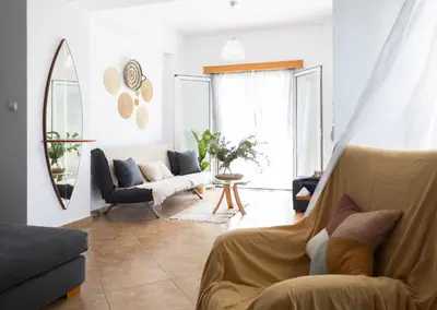 a living room with a couch and a chair at My Porto Villa in Porto Rafti