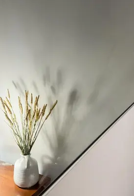 a white vase sitting on a table next to a wall at My Porto Villa in Porto Rafti