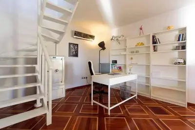 a room with a desk and a spiral staircase at Superior Penthouse in Athens Riviera in Athens