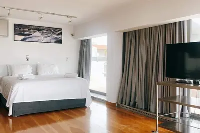 a bedroom with a bed and a flat screen tv at Superior Penthouse in Athens Riviera in Athens