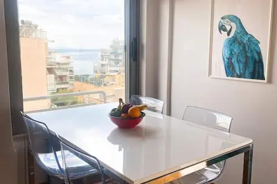 a white table with a bowl of fruit on it at Superior Penthouse in Athens Riviera in Athens