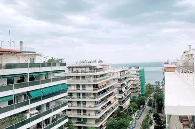 arial view of a building with the ocean in the background at Superior Penthouse in Athens Riviera in Athens