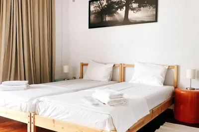 two beds sitting next to each other in a bedroom at Superior Penthouse in Athens Riviera in Athens