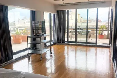 a living room with a hard wood floor and large windows at Superior Penthouse in Athens Riviera in Athens