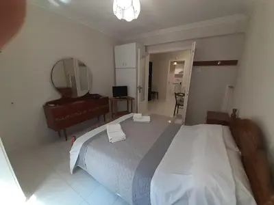 a bedroom with a large bed and a mirror at Central Apartment in Athens