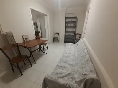 a bedroom with a bed and a table and chairs at Central Apartment in Athens