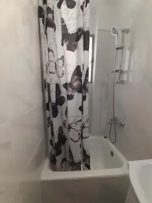 a black and white shower curtain in a bathroom at Central Apartment in Athens