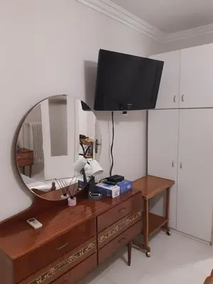 a mirror on top of a dresser with a television on it at Central Apartment in Athens