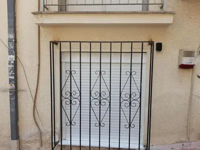a metal gate on the side of a building at Central Apartment in Athens