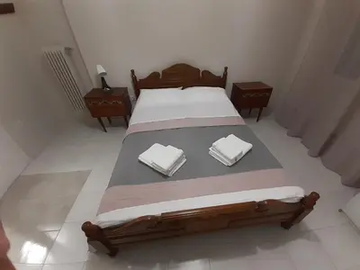 a bedroom with a bed with two towels on it at Central Apartment in Athens