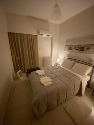 a bedroom with a large bed with towels on it at Athina’s apartment in Athens