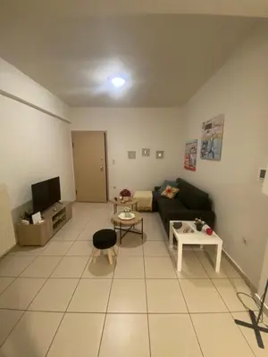 a living room with a couch and a table at Athina’s apartment in Athens
