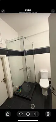 a bathroom with a shower and a toilet at Athina’s apartment in Athens