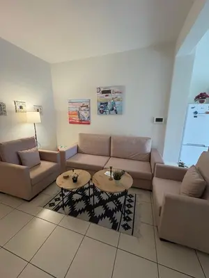 a living room with a couch and a table at Athina’s apartment in Athens