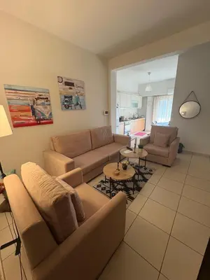 a living room with a couch and a table at Athina’s apartment in Athens