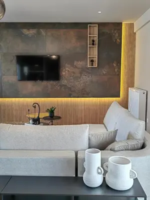 a living room with a couch and a tv at Lycabettus Vista Luxury Suite in Athens