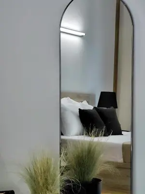 a mirror in front of a bedroom with a bed at Lycabettus Vista Luxury Suite in Athens