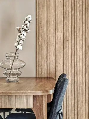 a wooden table with chairs and a vase of flowers at Lycabettus Vista Luxury Suite in Athens