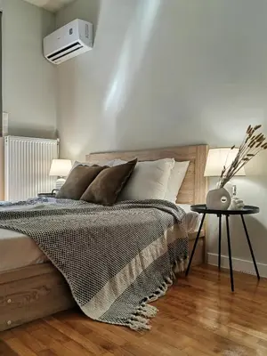 a bedroom with a bed with a black and white blanket at Lycabettus Vista Luxury Suite in Athens